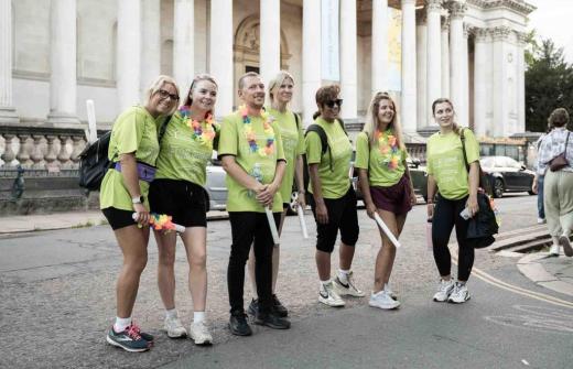 Group of men and women wearing green t-shirts outside Fitzwilliam Museum in Cambridge