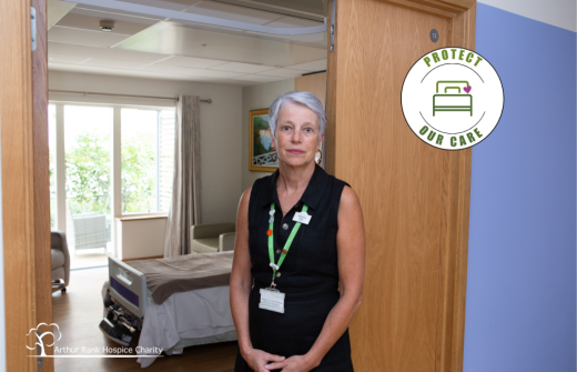 Female standing near a Hospice Bed 