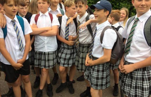 Group of schoolboys wearing skirts in protest at not being allowed to wear shorts in hot weather