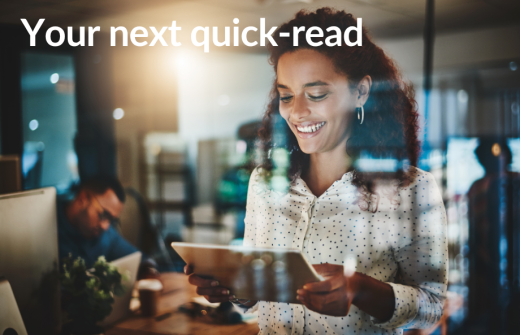 A woman reads news on her tablet looking delighted