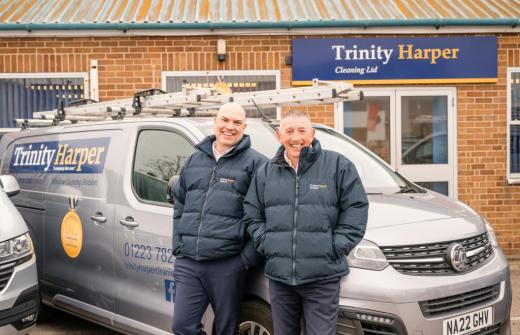 Paul and Barry from Trinity Harper cleaning smiling next to their vans