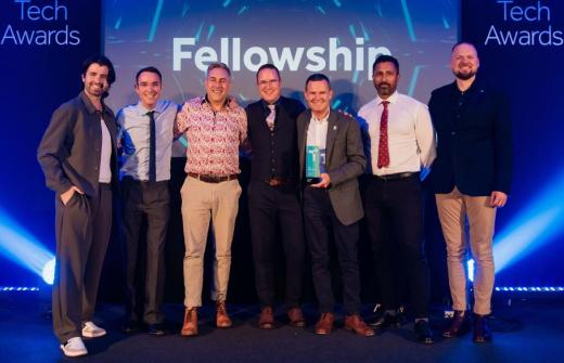 Fellowship team on stage receiving an award at the UK Business Tech Awards for digital agency of the year.