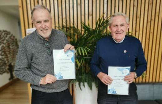 2 males holding certificates 