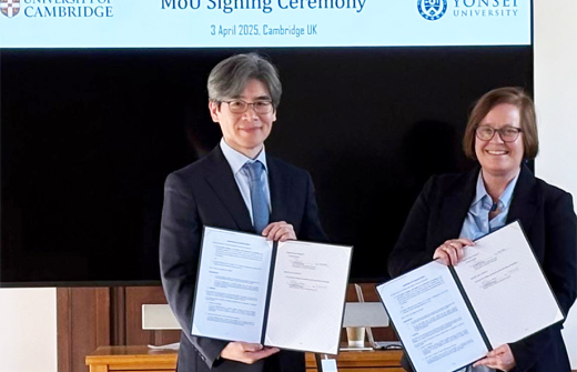 Representatives of Yonsei University and the Milner Institute holding signed copies of their new agreement