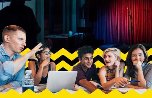 Five people talking and looking at a computer screen