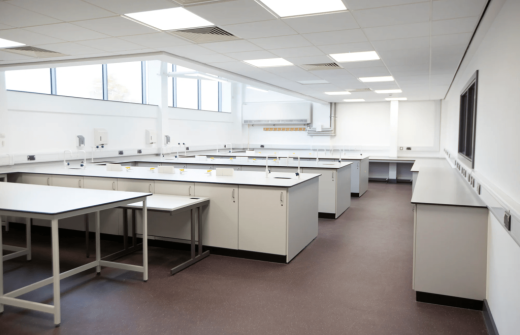 A large lab space with big windows and white worktops