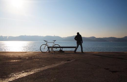 Person on a beach with bicycle