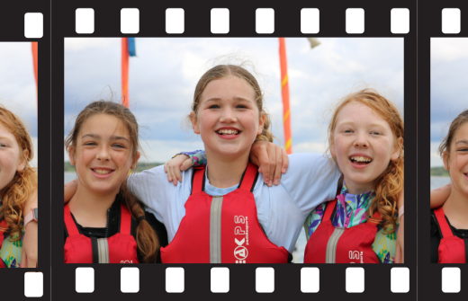 Image of film strip showing three smiling girls wearing lifejackets