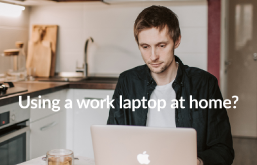 man using his work laptop at home on the kitchen table