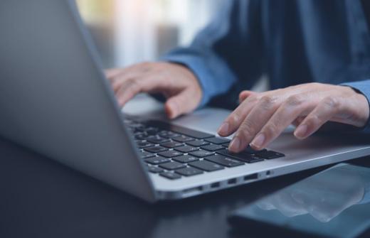 man typing on laptop 