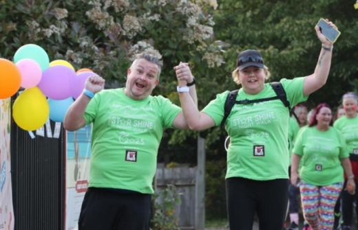 Men in green t-shirts smiling 