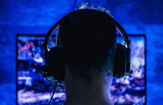 silhouette of gamer with headphones on