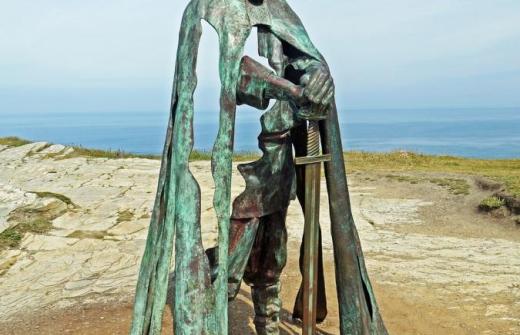 A bronze statue of a man holding a sword