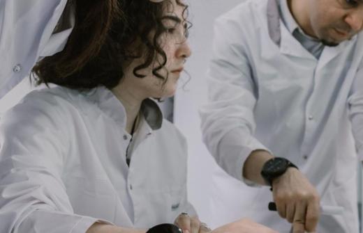 3 people in a white shirts talking 