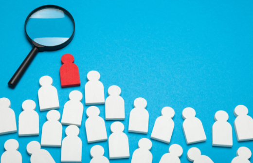 many white figures with one red figure standing out