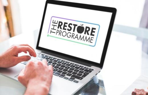 and laptop with the words the restore programme