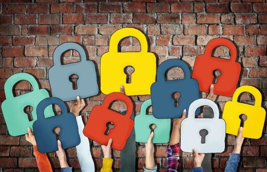 People holding security locks in-front of a wall