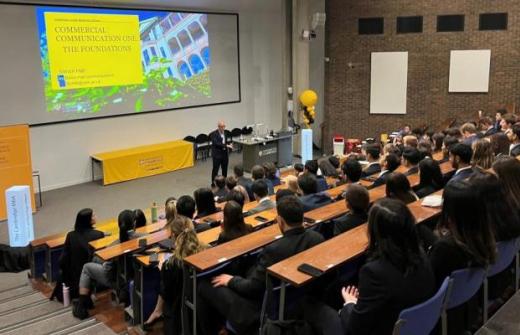 Simon giving a presentation to a large group