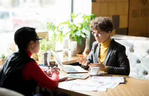 Two science marketing professionals discussing Account-Based Marketing strategies to boost B2B biotech sales and lead generation through data-driven insights.