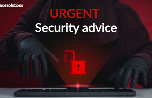 a dark figure looms over a laptop keyboard with a bright red padlock superimposed