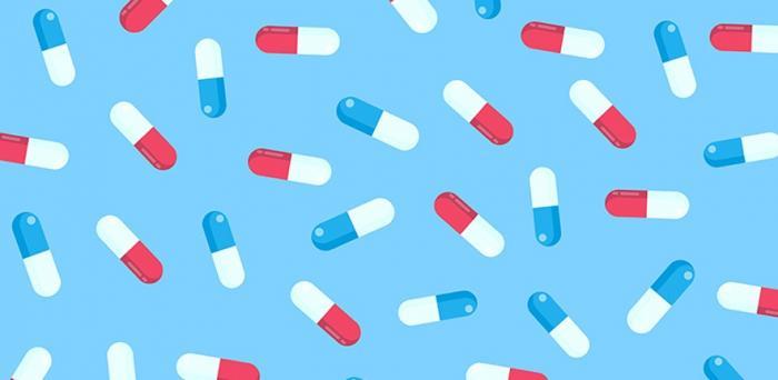 drug capsules on a blue background