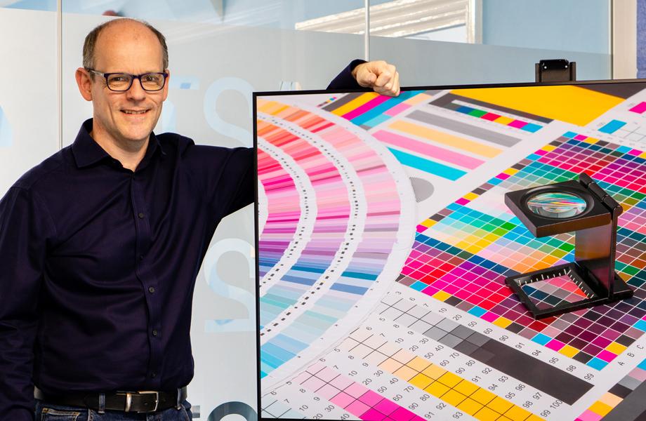 Image shows Dr Euan Smith, head of systems and photonics at 42T with printed colour samples