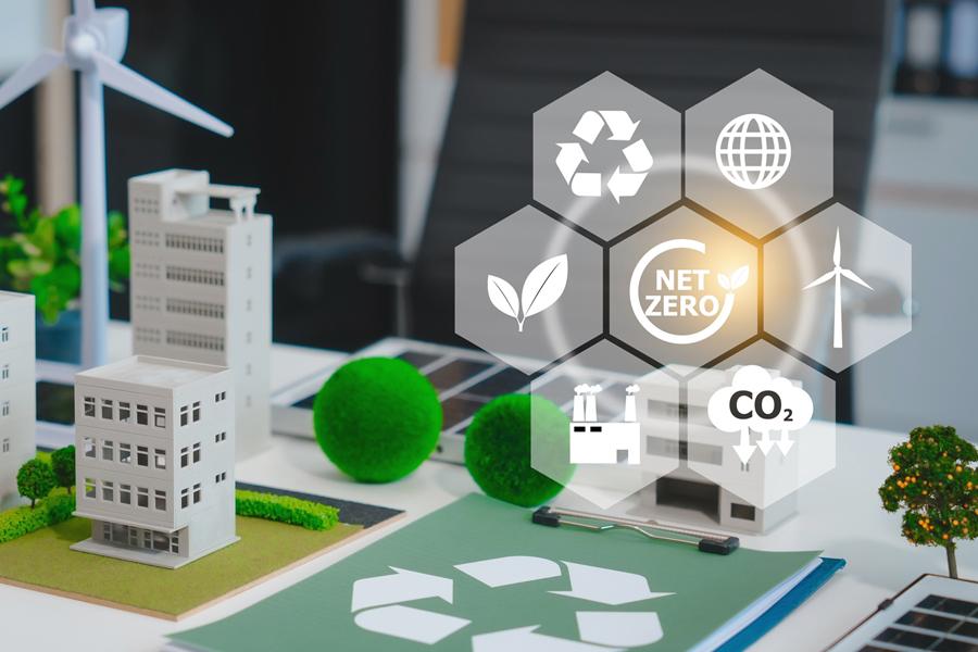 Image shows building, wind turbine and various symbols associated with net zero, carbon reduction and recycling.