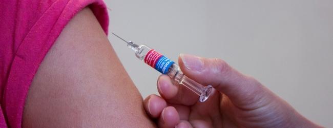 syringe about to be put into a bare arm
