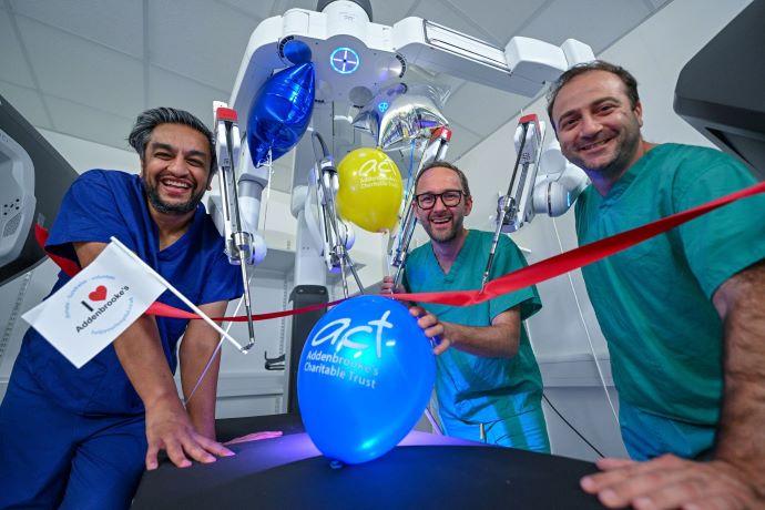 CUH consultant surgeons Mr Michael Powar, Professor Grant Stewart and Mr Constantinos Simillis with the new surgical robot.