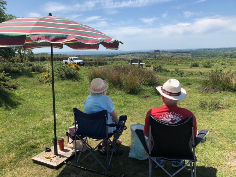 Two people enjoying a thoughtful view of the countryside