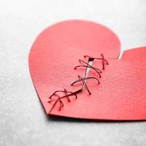 Broken heart depicted  in paper tied together with string_ BHF image