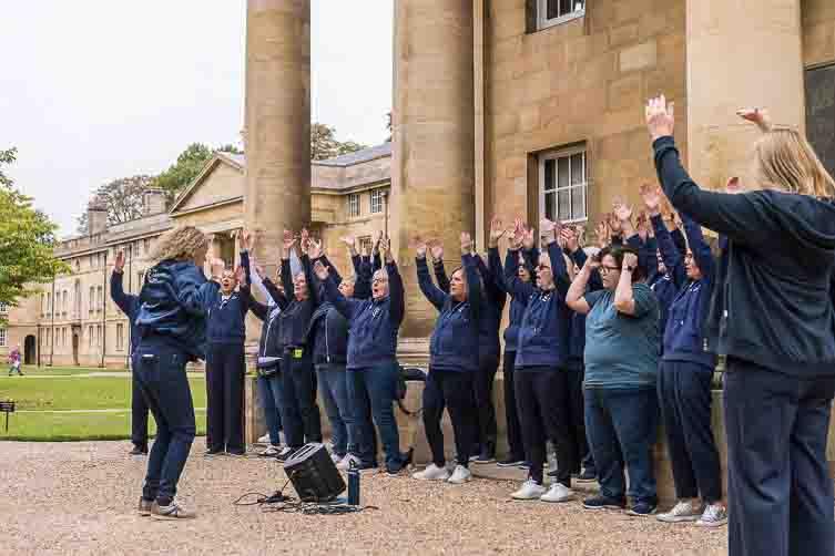 Males and females singing outside 