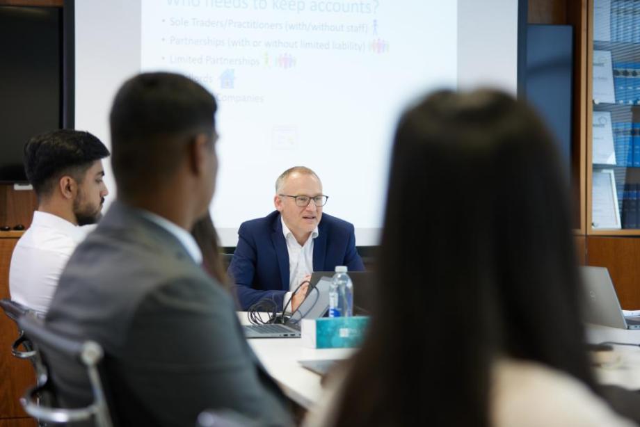 Price Bailey trainees sit together in a meeting