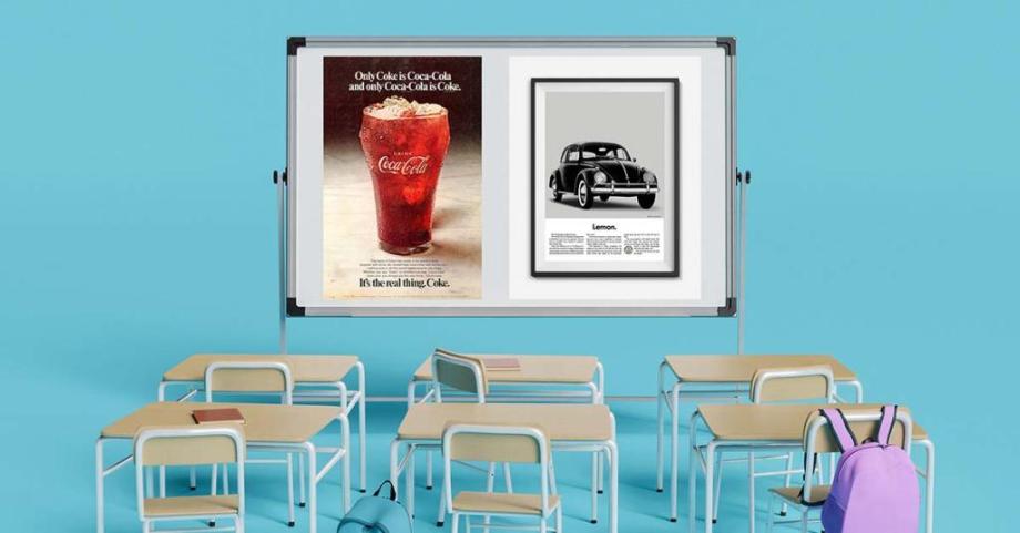 A classroom with two iconic advertisements for Coca Cola and VW Beetle on the board at the front.
