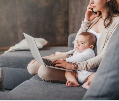 woman with child on lap, with laptop, talking on the phone/ https://www.canva.com/
