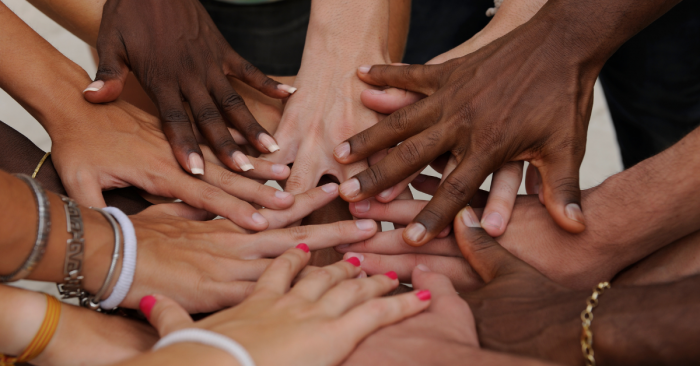 many hands connecting in a circle