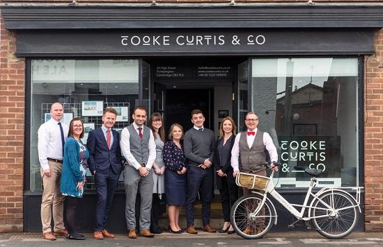 The team at Cooke Curtis & Co - pictured before the pandemic