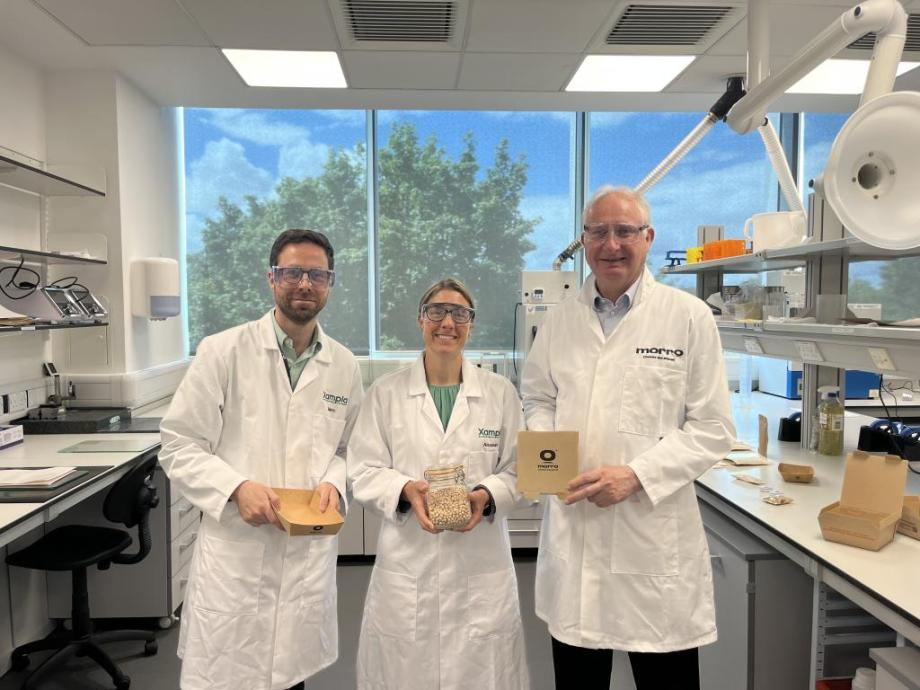 3 people in white lab coats holding Xampla products
