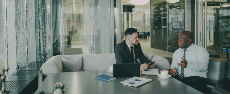 two men sitting down having a relaxed meeting