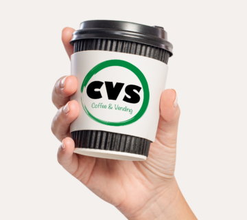 Hand holding CVS branded coffee cup.