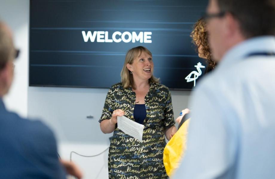 A female talking to a group of people
