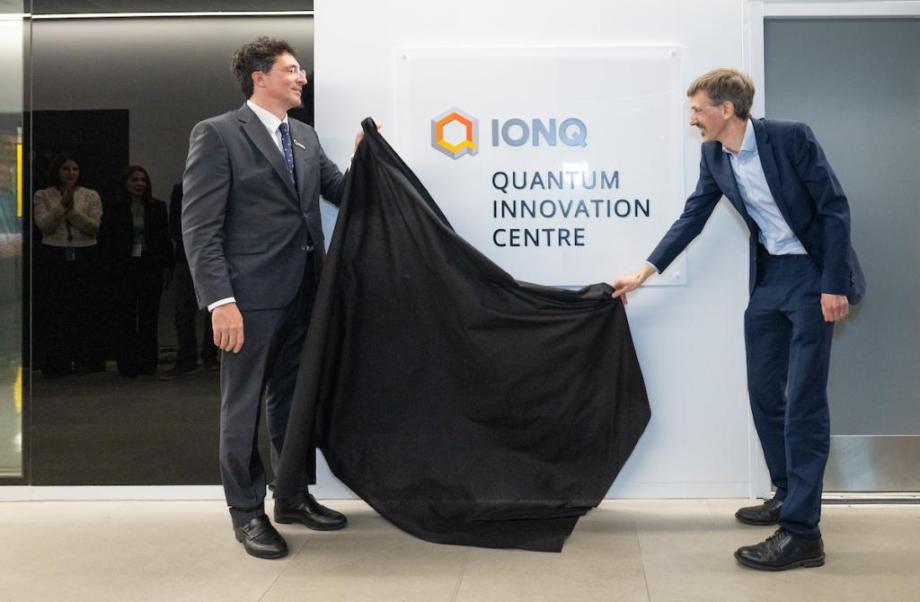 2 men revealing a plaque 