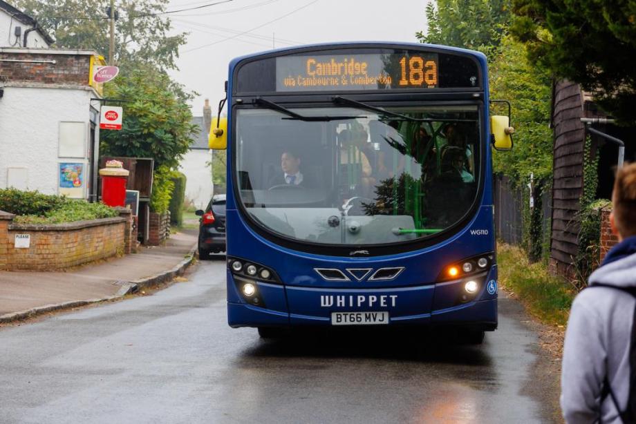 A bus pulling in to pick someone up