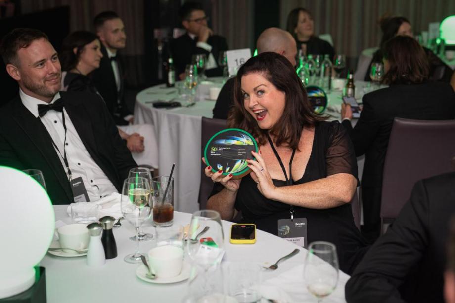Monavate employee with award
