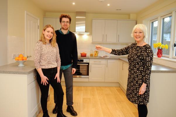 Left to right: Florence and Callum receive the keys to their new home from Ann Bonnett, Chair of Girton Town Charity.