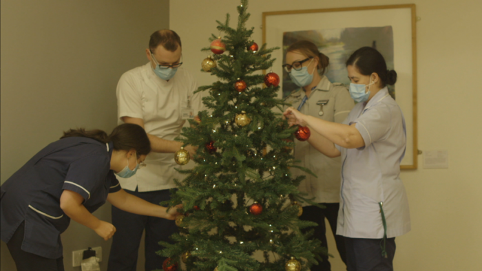 Staff decorate the Christmas tree - a still from Arthur Rank Hospice Charity’s Light up a Life film premiere, which replaced the physical event this year. 