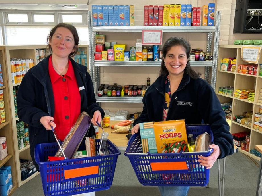 Rachel Karniely and Nicky Shepard holding baskets of food at Abbey Food Hub