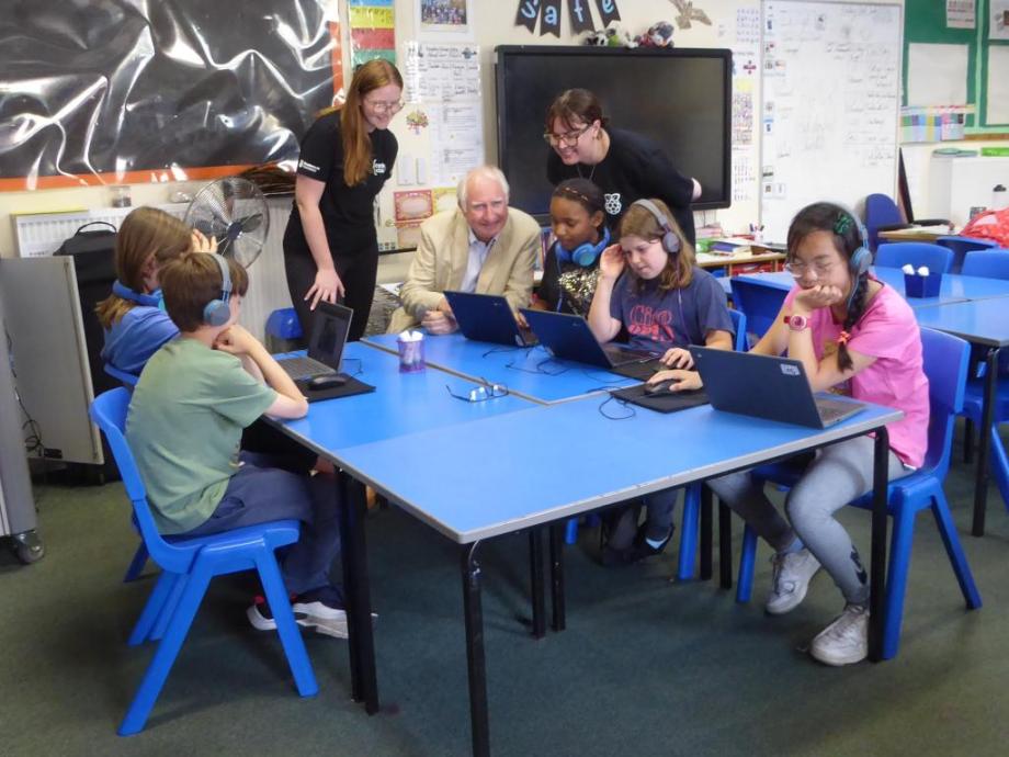 a man talking to children in a school setting 