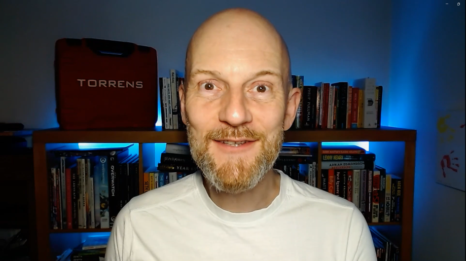 A smiling bald man