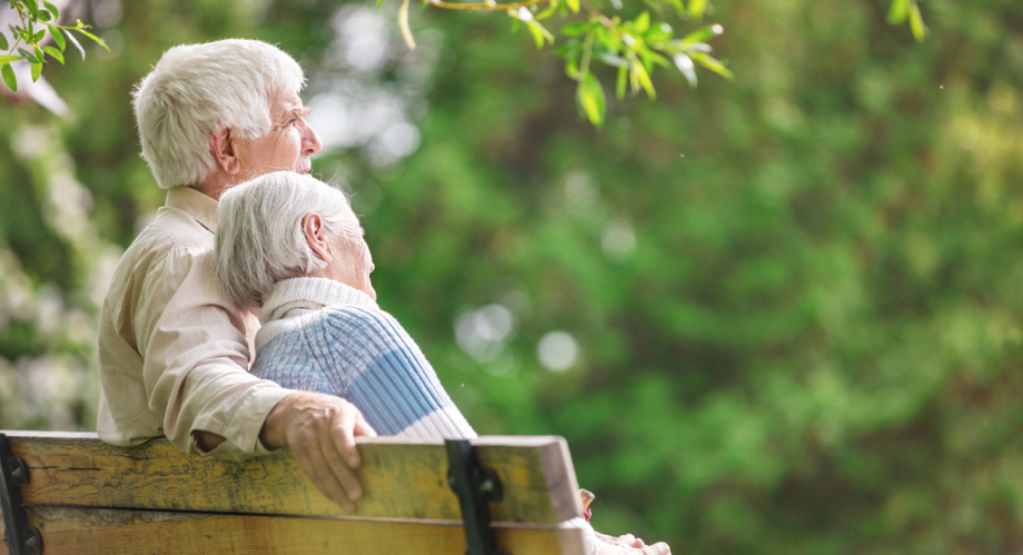 A mature couple sitting on a bench